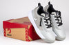 Grey/Black BILLY Sport Court Athletic Sneakers for kids on a shoebox, featuring laces and zippers for easy on and off.