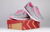 Grey and fuchsia Billy joggers for kids with laces and zipper; easy on/off; shown on a branded shoebox; functional and fashionable design.