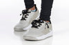 Child wearing grey and black BILLY Sport Court sneakers with laces and zipper for easy on/off, promoting independence and style.